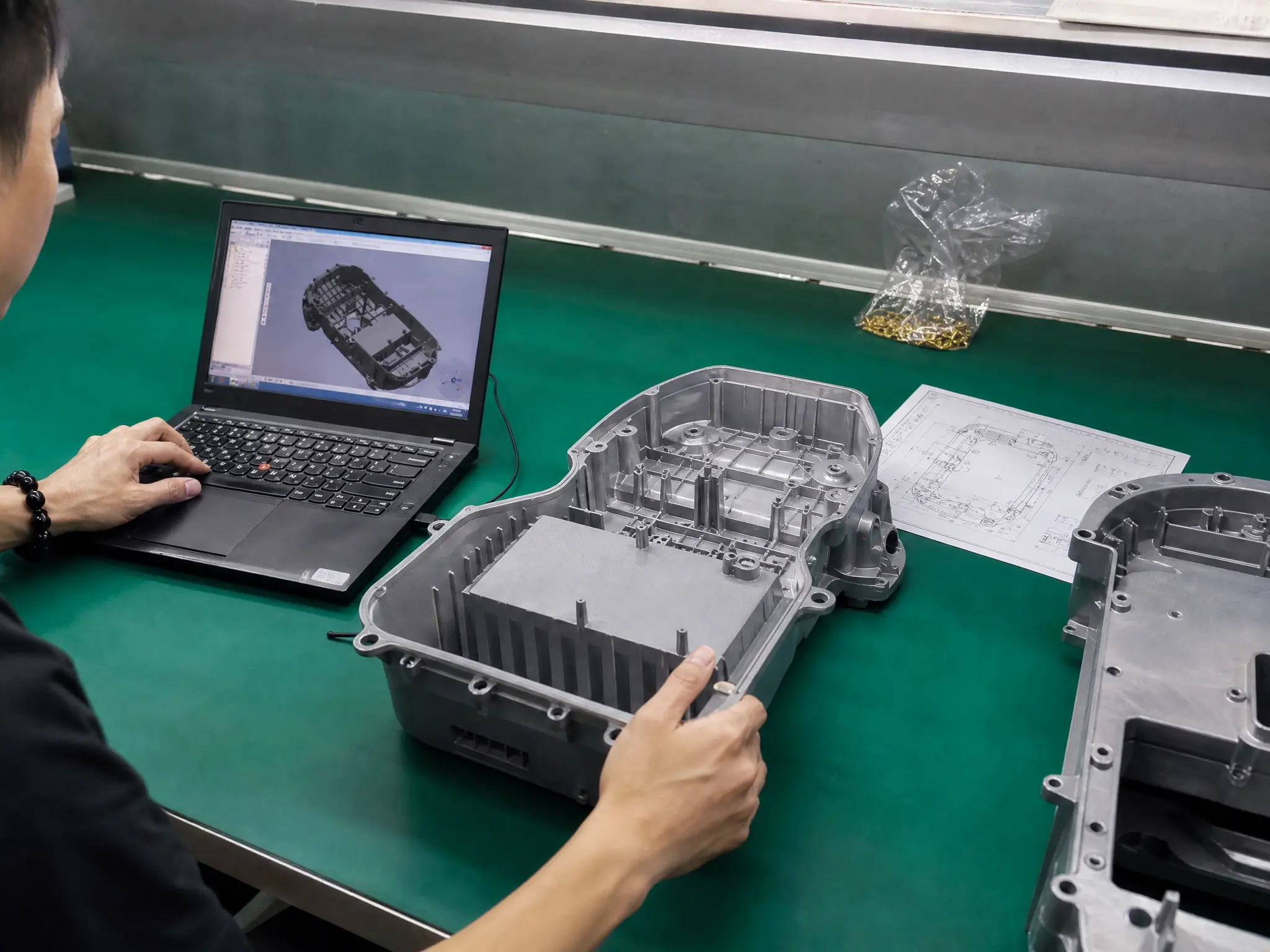 PanGao Leader R&D engineer inspecting 3D CAD design and molded metal enclosure